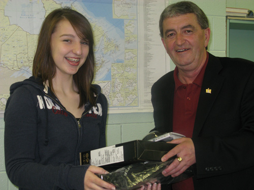 Clayton Forsey, the MHA for Exploits, presents Financial Fitness Challenge winner, Tiffany Sceviour, with her new notebook computer.