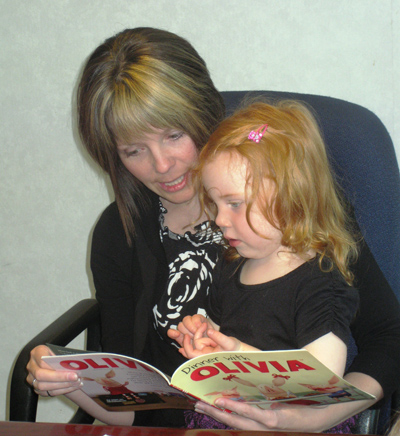 The Honourable Charlene Johnson, Minister of Child, Youth and Family Services, reads a story.
