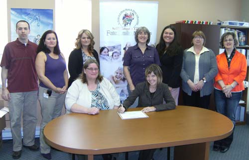 The Honourable Charlene Johnson, Minister of Child, Youth and Family Services (CYFS) meets with members of the Newfoundland and Labrador Foster Families Association (NLFFA) to sign the proclamation for Foster Families Week 2011, taking place from October 16 to 22. Front Row: (Left to Right) Ruby Ellsworth, Vice-Chair, NLFFA board; Minister Johnson. Back Row: Steve Halley, social worker, CYFS;  Denise Patey, Program Manager, CYFS; Kay Patey, foster parent; Diane Molloy, Executive Director, NLFFA; Melody Morton-Ninomiya, foster parent; Georgina Bown, foster parent; Amy Kendall, social worker, NLFFA.