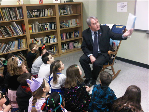 Education Minister Clyde Jackman reads to Grade 3 students at Donald C. Jamieson Academy in Burin Bay Arm. 