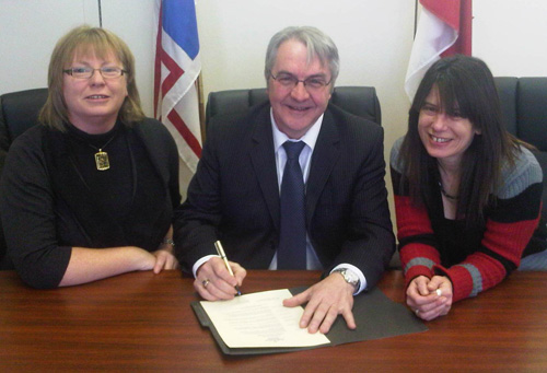 Education Minister Clyde Jackman signs a proclamation declaring February Inclusive Education Month in Newfoundland and Labrador. Minister Jackman was joined by Kelly White, left, Executive Director of the Coalition for Persons with Disabilities and Natasha McDonald, Executive Director of the Newfoundland and Labrador Association for Community Living.