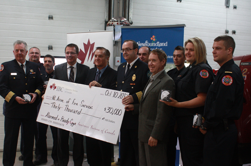 Insurance Bureau of Canada's Bill Adams, Municipal Affairs Minister Kevin O'Brien and Newfoundland and Labrador Association of Fire Services  launch the Alarmed and Ready Challenge with members of the Portugal Cove-St. Philips fire department, October 10, 2012.