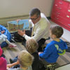 The Honourable Paul Davis, Minister of Child, Youth and Family Services reads <i>What’s Going On at the TIME Tonight?</i> by Newfoundland and Labrador author Gerald Mercer during story time at Memorial University’s Childcare Centre - November 20, 2013