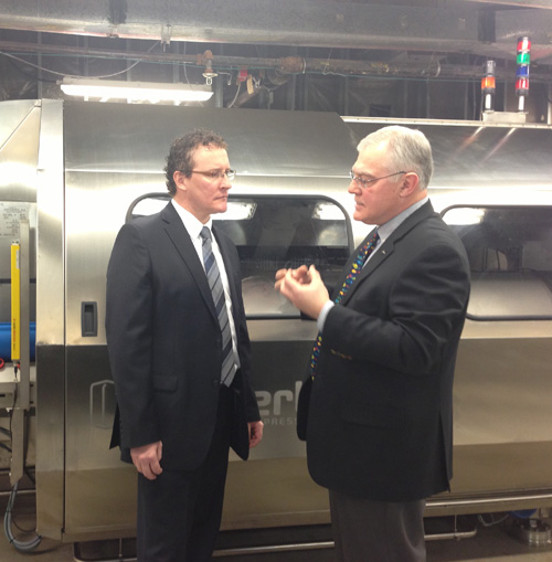 The Honourable Derrick Dalley, Minister of Fisheries and Aquaculture, receiving a tour of the recently installed high pressure seafood processing unit at the Fisheries and Marine Institute from Bob Verge, Managing Director of the Canadian Centre for Fisheries Innovation. April 15, 2013.