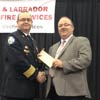 Vaughn Granter, MHA for Humber West, makes a cheque presentation of $101,000 for the Newfoundland and Labrador Association of Fire Services. Receiving the cheque is President Vince MacKenzie.