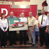 The Honourable Kevin O'Brien, Minister of Municipal Affairs and Minister Responsible for Fire and Emergency Services-Newfoundland and Labrador, along with Glen Little, MHA for Bonavista South, and members of the Lethbridge fire service unveil a picture of the new fire truck for the area - August 7, 2013.