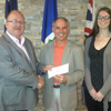On behalf of the Honourable Terry French, Minister of Tourism, Culture and Recreation, Vaughn Granter, MHA for Humber West presented the $15,000 grant to Neville Greeley Mayor City of Corner Brook and Jessica Parsons Supervisor of Recreation Services City of Corner Brook.