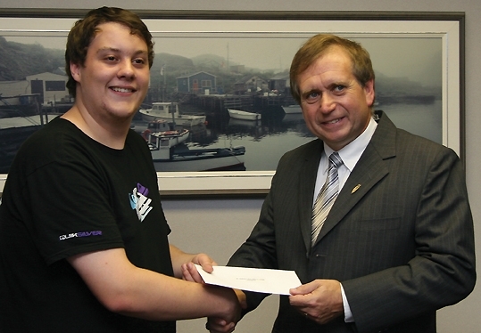 The Honourable Tom Hedderson Minister of Fisheries and Aquaculture, presents Andrew Chaulk of Lewisporte with the second annual Department of Fisheries and Aquaculture scholarship.