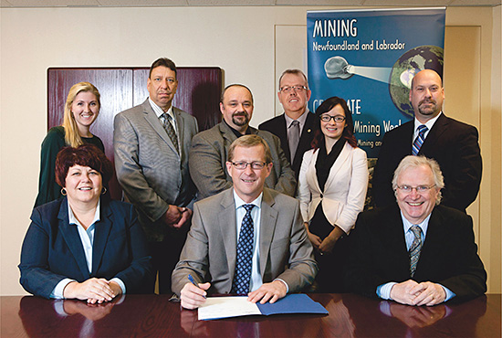 The Honourable Jerome P. Kennedy, Q.C., Minister of Natural Resources, signs the proclamation for Provincial Mining Week 2012. Front row (left to right): Heather Bruce-Veitch, Director of External Relations, Rio Tinto IOC; Minister Kennedy; and Gerry O’Connell, Executive Director, Mining Industry NL. Back row (left to right): Amanda McCallum, Outreach Geologist, Geological Survey of Newfoundland and Labrador, Department of Natural Resources; Robert Wheeler, Senior Geologist, Vale Newfoundland and Labrador; Rod Churchill, Geoscience Director, Professional Engineers and Geoscientists of Newfoundland and Labrador; Allan Cramm, Honourary Chair of Mining Week and the CIM Newfoundland Branch President; Sarah Smith, President, Alexander Murray Geological Club, Memorial University; and Charles Bown, Deputy Minister, Department of Natural Resources.