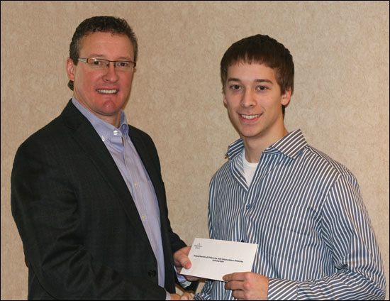 Education Minister Clyde Jackman reads to Grade 3 students at Donald C. Jamieson Academy in Burin Bay Arm. 
